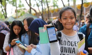 Indonesian adolescent girls use their smartphones.
