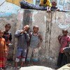 孩子们在索马里首都摩加迪沙的后街等待接种小儿麻痹症疫苗。