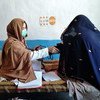 A new mother is examined by a mobile health team midwife in Afghanistan. 