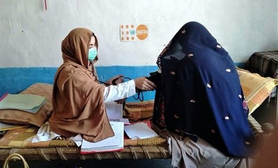 A new mother is examined by a mobile health team midwife in Afghanistan. 