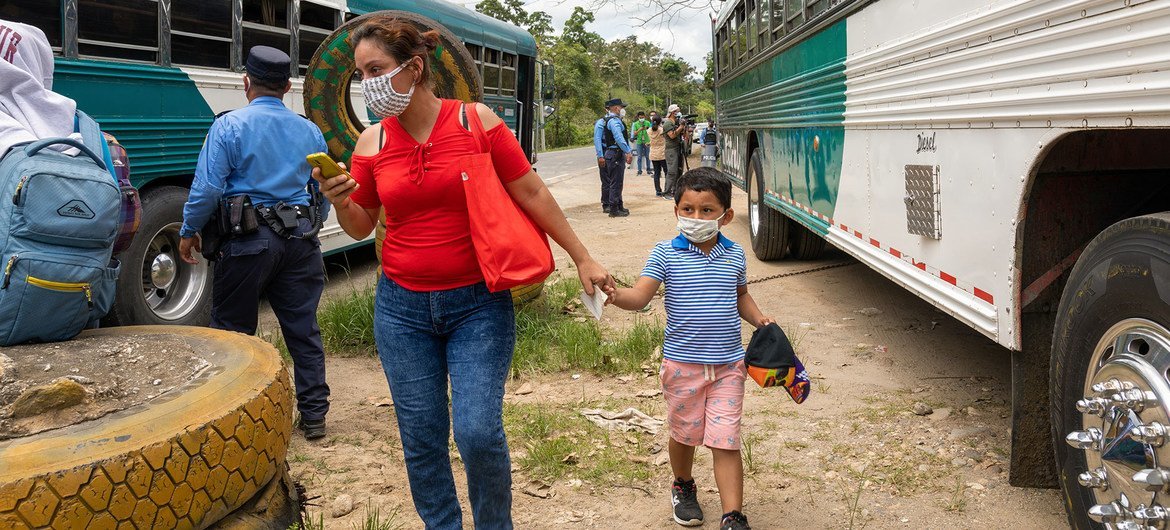 In Honduras, close to the Corinto border with Guatemala, police stop buses carrying migrants to check documentation and COVID test results.