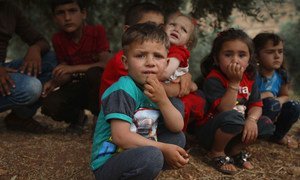  Children rest beneath a tree in the Syrian Arab Republic. Their families have set up makeshift camps in Aqrabat village, 45km north of Idlib City, near the Turkish border.