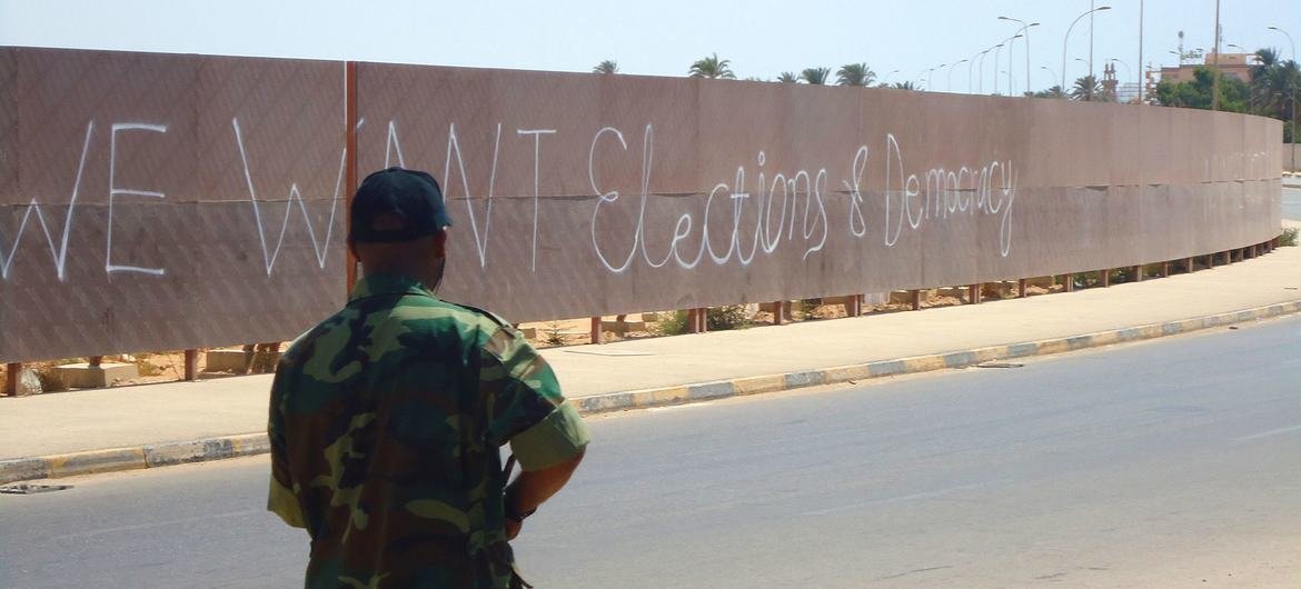 Graffiti on a wall in Benghazi, Libya, calls for elections and democracy.