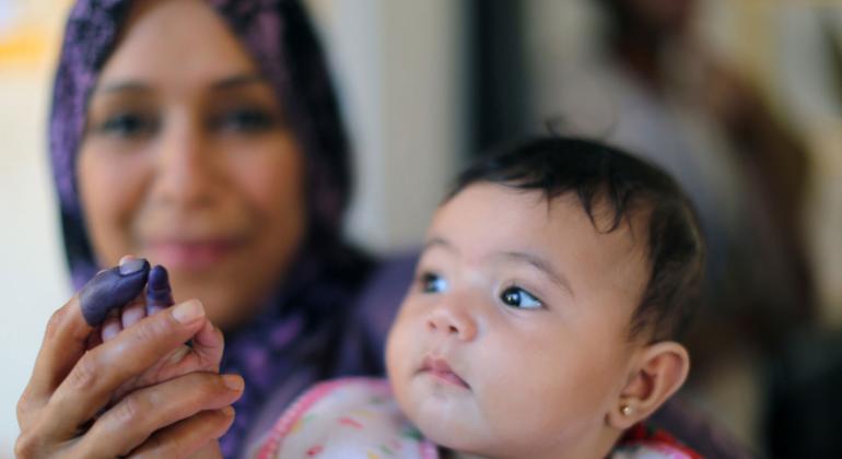 A mother holds up hers and her daughter's inked fingers at a polling station in the eastern city of Benghazi after casting her vote in historic elections. The proud display of inked fingers became a fad for many Libyans stressing their newfound right to vote.
