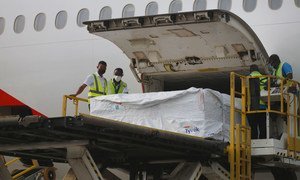 Staff unload the first shipment of COVID-19 vaccines distributed by COVAX at Kotoka International Airport in Accra, Ghana's capital.