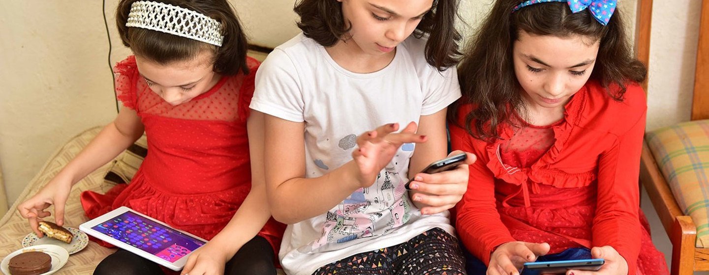 Young girls in Turkey use their digital devices.