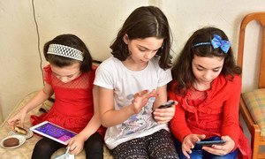 Young girls in Turkey use their digital devices.