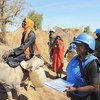 Peacekeepers from the African Union-UN Hybrid Operation in Darfur (UNAMID) provide protection to local women in Aurokuom village, Sudan.