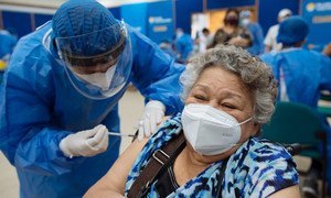 A Venezuelan refugee receives her first dose of the COVID-19 vaccine in Guayaquil, Ecuador.