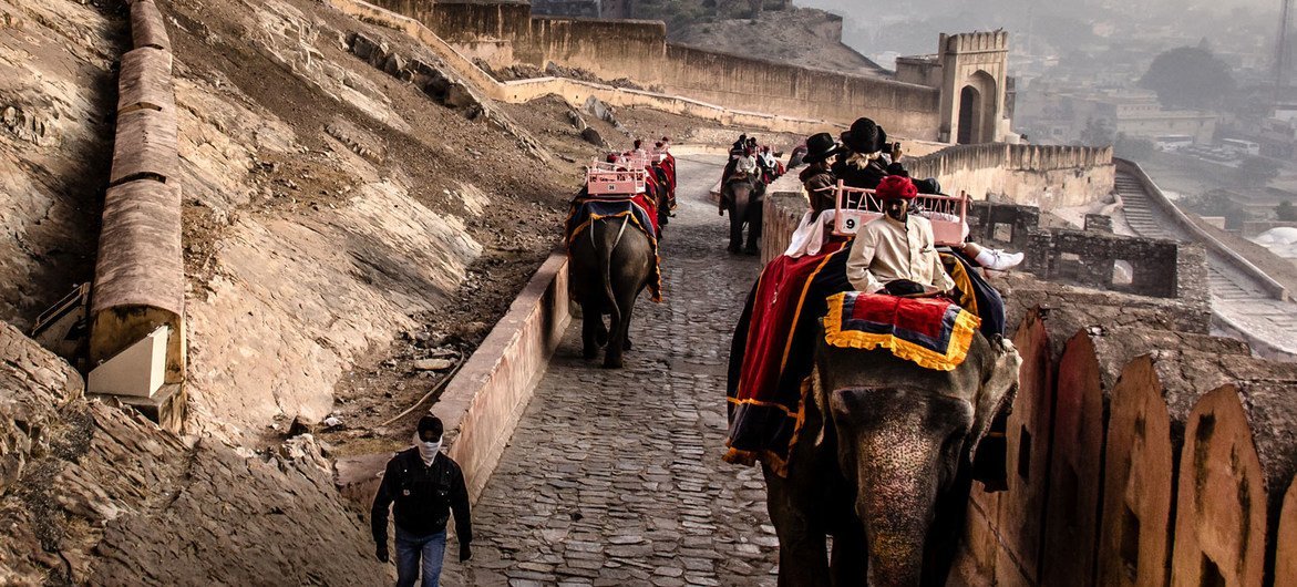 Tourists in India take an elephant ride at the Amber Fort, outside of Jaipur.