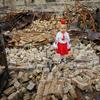A young girl stands in the rubble of her damaged school in Horenka, in the Kyiv region of Ukraine.