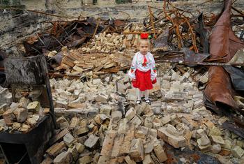 A young girl stands in the rubble of her damaged school in Horenka, in the Kyiv region of Ukraine.