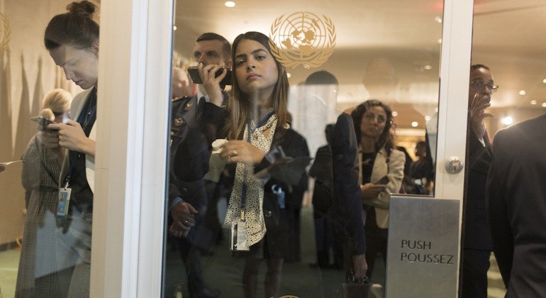 Delegates, officials and UN staff members wait outside the General Assembly Hall prior to the opening of the 74th session. 