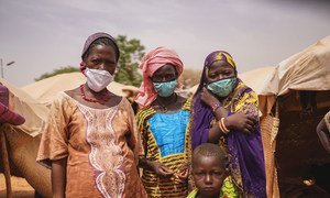 In Niger attacks by armed groups have been on the rise, exacerbating the plight of communities reeling under the impact of the pandemic. Pictured here, a woman with members of her family, who were forced to flee their homes due to violence and insecurity. 