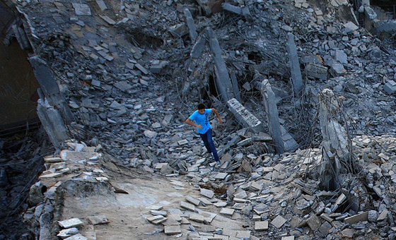 A boy runs in the ruins of the Bab al-Aziziyah compound in Tripoli, Libya.