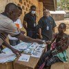 Dans un centre de vote de la capitale Bangui, une jeune femme centrafricaine vient retirer sa carte d'électeur en vue des élections présidentielle et législatives du 27 décembre 2020