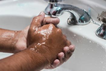 A man washing his hands, one of the preventive measures to be protected from COVID-19 infection.