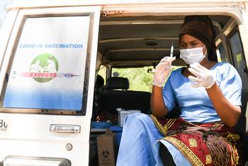 मलावी में एक स्वास्थ्यकर्मी, कोविड-19 वैक्सीन का टीका लगाने की तैयारी करते हुए.