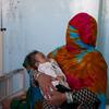 أم تحمل طفلها المصاب بسوء التغذية في مستشفى مرويس الإقليمي في قندهار ، أفغانستان.
