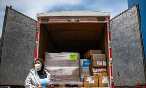 Health workers at a warehouse in Jakarta receive medical equipment from UNICEF to support Indonesia’s health authorities in the response to COVID-19.
