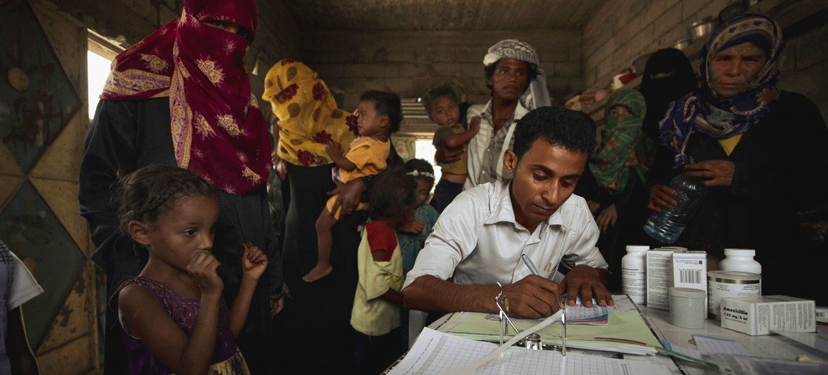 A medical worker registers patients in a village in Yemen.