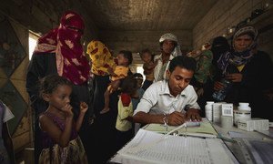 A medical worker registers patients in a village in Yemen.