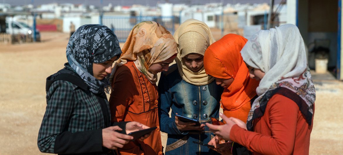 Adolescent girls use cellphones and tablets in the Za'atari camp for Syrian refugees (file).