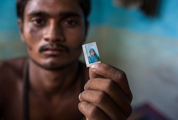 A migrant labourer in India holds a photo of his mother who was killed in a road accident as they returned home during the COVID-19 pandemic.