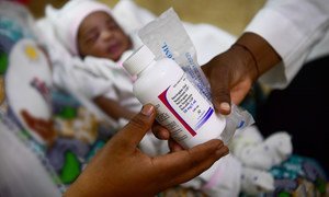 An HIV-positive woman receives medication for her three-day-old baby at a hospital in Ouagadougou, Burkina Faso. Critical HIV services in many countries have been disrupted due to the coronavirus pandemic.