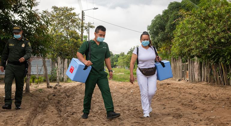 A vaccination team goes door-to-door in a working class neighbourhood of Puerto Inirida, Colombia, to offer COVID-19 vaccinations.