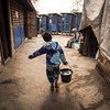 About one million people, affected by conflict and natural disasters, are in need of humanitarian aid and protection in Myanmar. Pictured here, a 12-year-old child fetches water for his household at an IDP camp in Kachin state. (file photo)