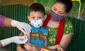 A young boy is vaccinated against measles and rubella during a national vaccination campaign in Bangladesh.