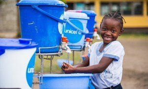 A young girl washes her hands at a primary school in the Democratic Republic of the Congo.