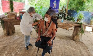 An indigenous man receives his COVID-19 vaccination in Brazil.