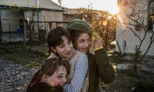 Three young women displaced by the 2008 conflict in the Republic of Georgia stand outside a psychosocial support centre in an IDP settlement in Shavshvebi.