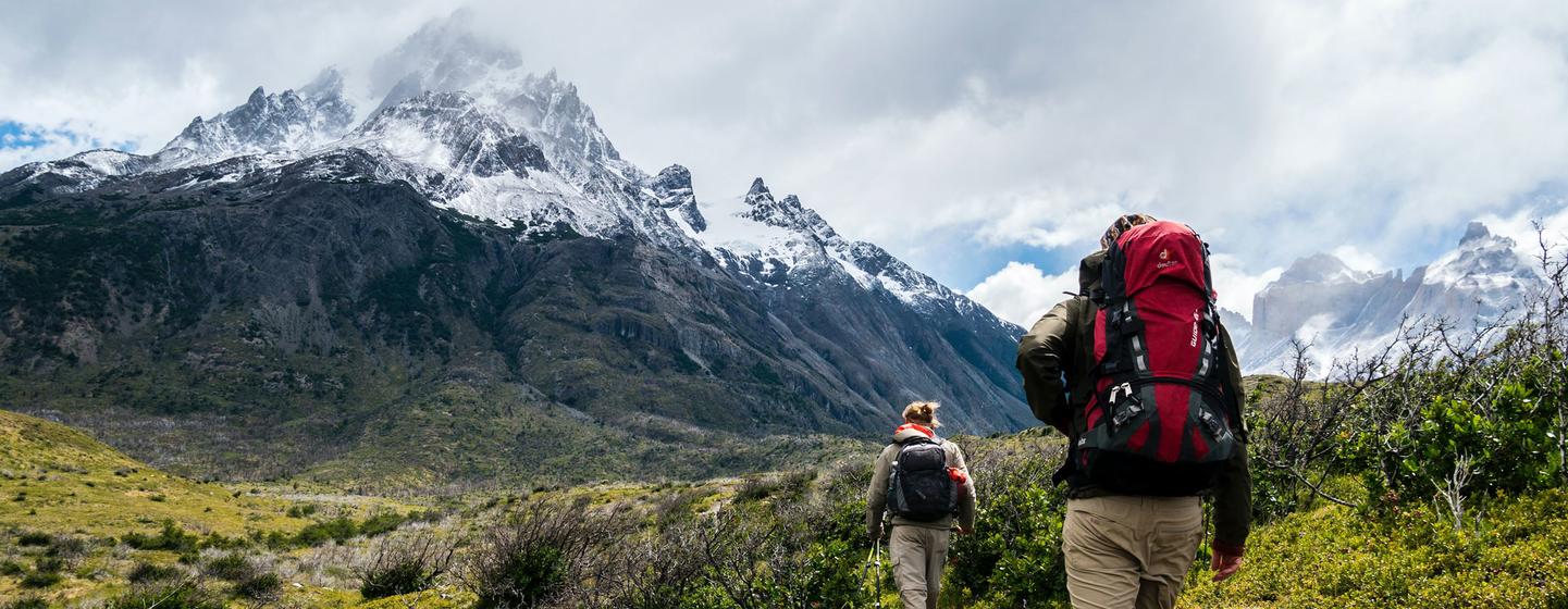 Two hikers trek the mountains of Chile.
