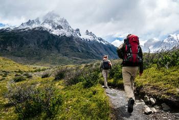 Two hikers trek the mountains of Chile.