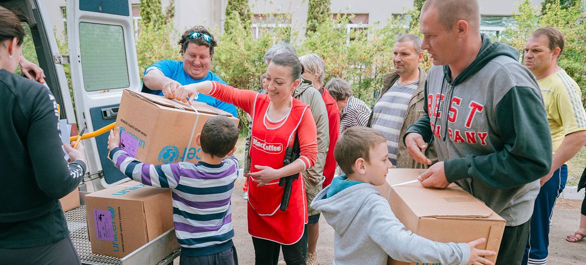 A family receives humanitarian aid at a health centre in Kharkiv, Ukraine..