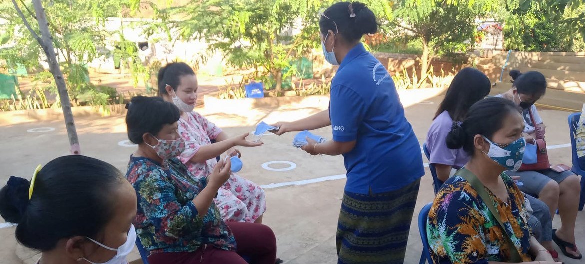 Masks are distributed in a quarantine facility during an awareness raising activity about the dangers of COVID-19. 