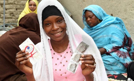 In the center of Chad, 19-year-old Achta holds up condoms during an HIV awareness-raising session in her Moussoro community. (March 2019)