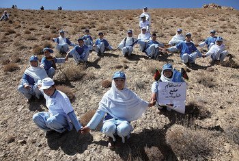 Young Afghans join hands as they embark upon a demonstration of peace in Bamyan, Afghanistan.