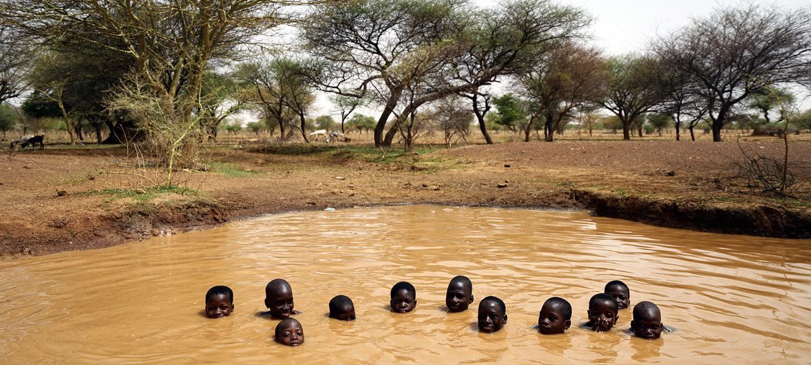 Niños jugando en un pozo de agua cerca de la ciudad de Kaya en el norte de Burkina Faso.