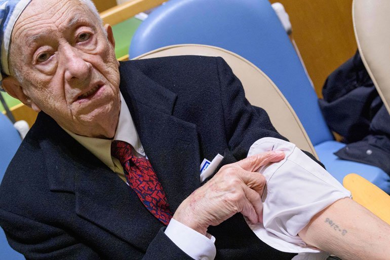 Sal Birenbaum, survivor of Auschwitz, shows the number tattooed on his arm prior to the United Nations Holocaust Memorial Ceremony.