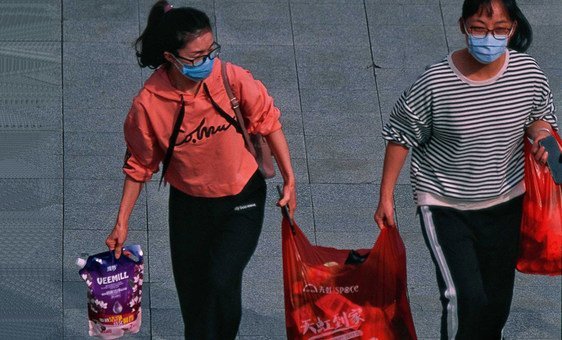 Two women in Shenzhen, China, on their way to work, amid the ongoing coronavirus outbreak.