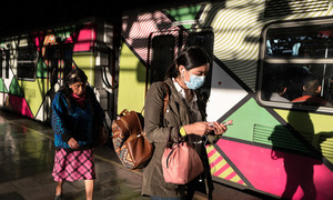 Two women walk in a Mexico City subway station during the coronavirus crisis.
