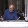 Simon Gronowski plays the piano for passers-by from his home in Brussels, Belgium.