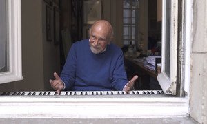 Simon Gronowski plays the piano for passers-by from his home in Brussels, Belgium.