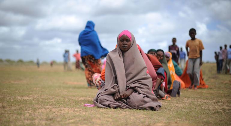 Women wait for food aid at a distribution centre in Afgoye, Somalia.