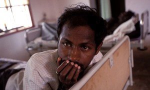 Man with AIDS being cared for in a hospital in India. 