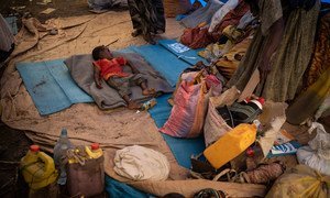 A young Ethiopian refugee sleeps on a mattress at a transit site in Hamdayet, Sudan.